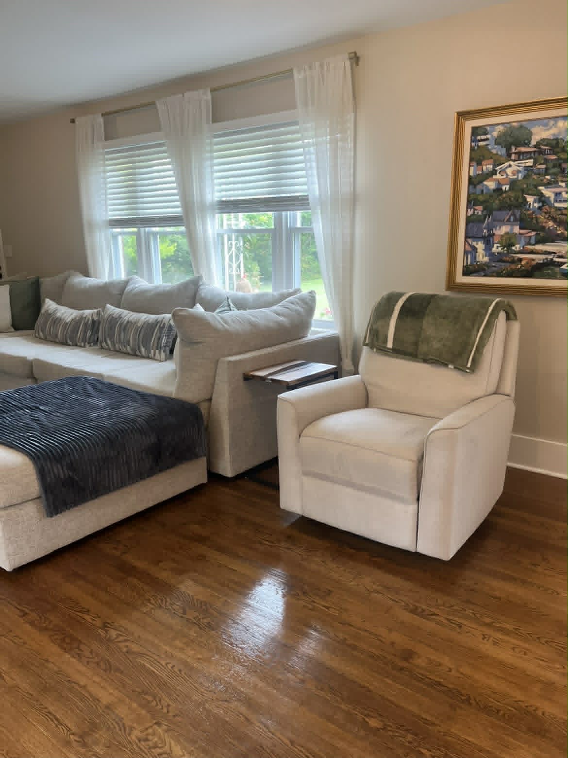 Bright living room with beige sectional and hardwood floors