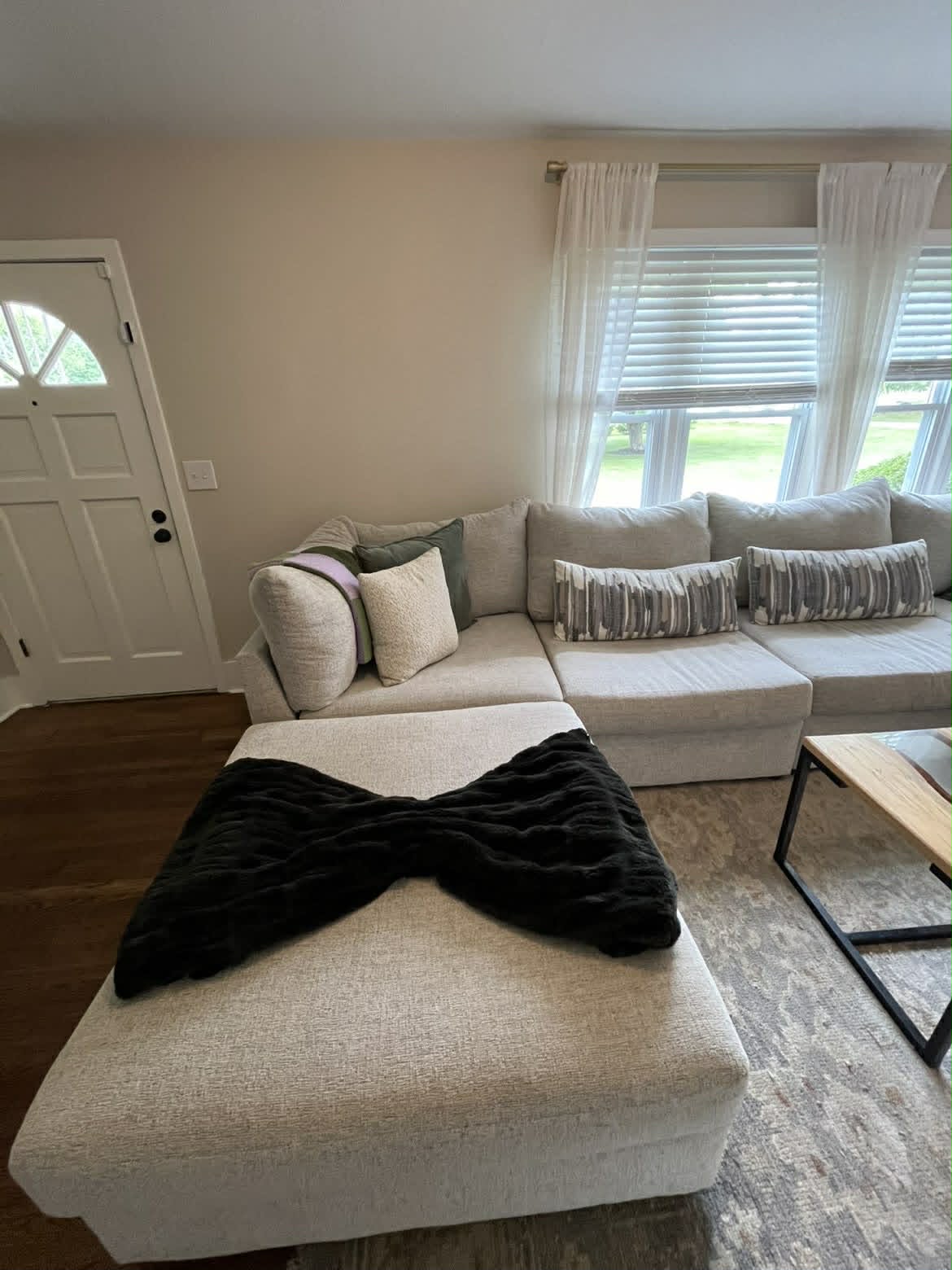 Clean living room with large beige sectional