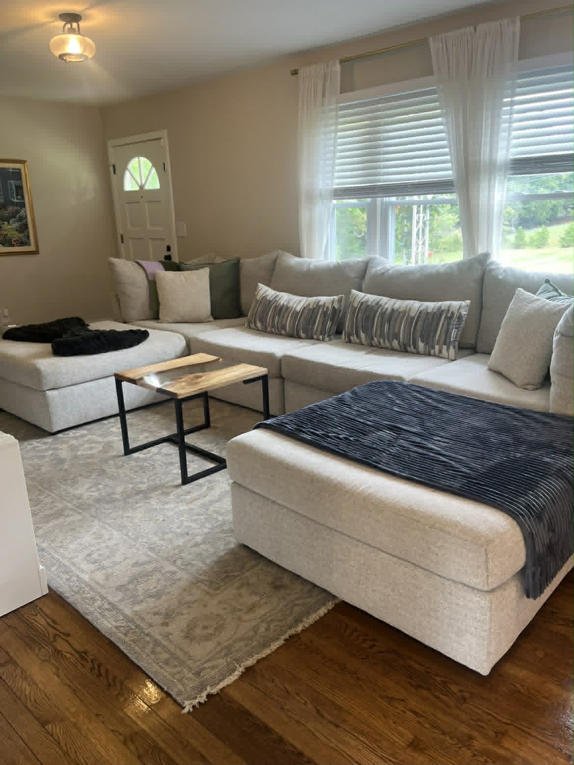 Living room with beige sectional from wide angle