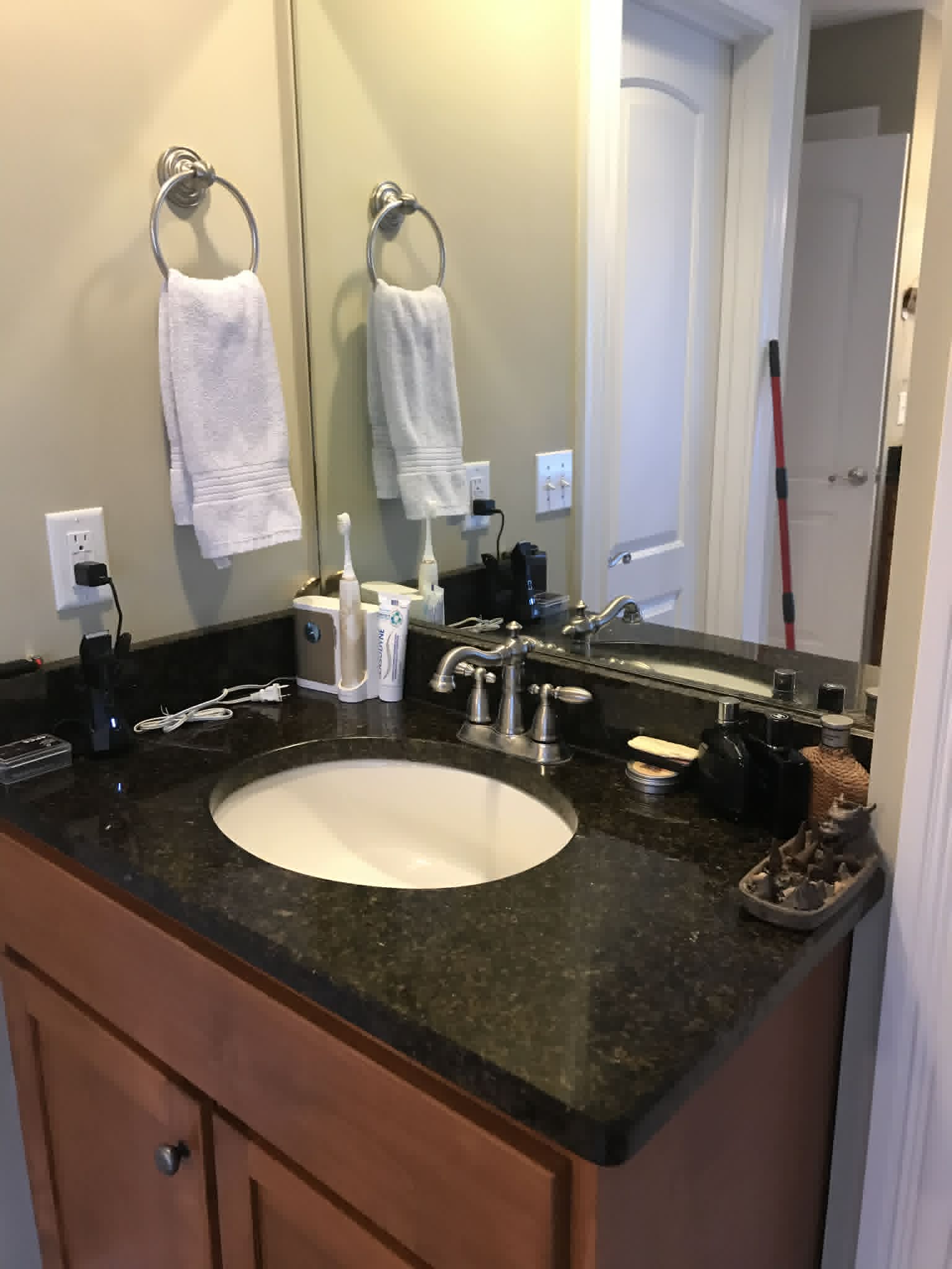 Bathroom vanity after — clean dark granite sink