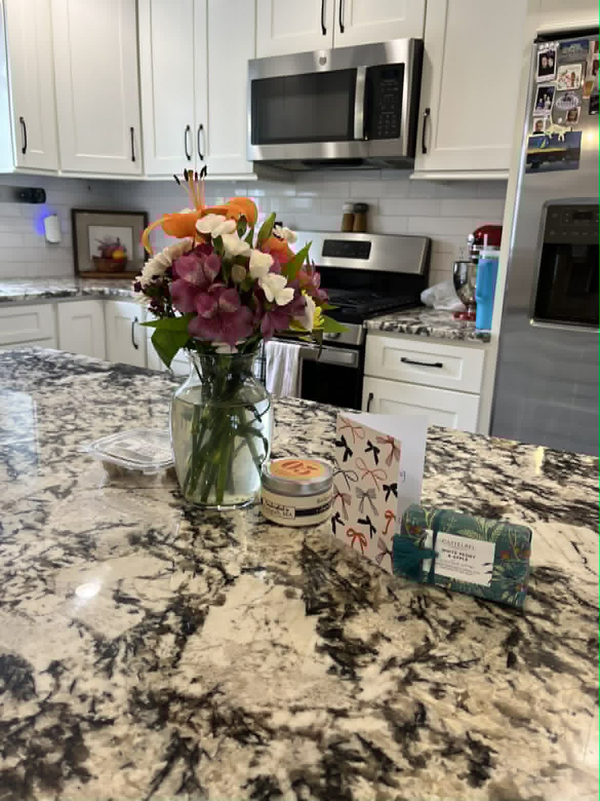 Clean kitchen island with flowers and granite counter