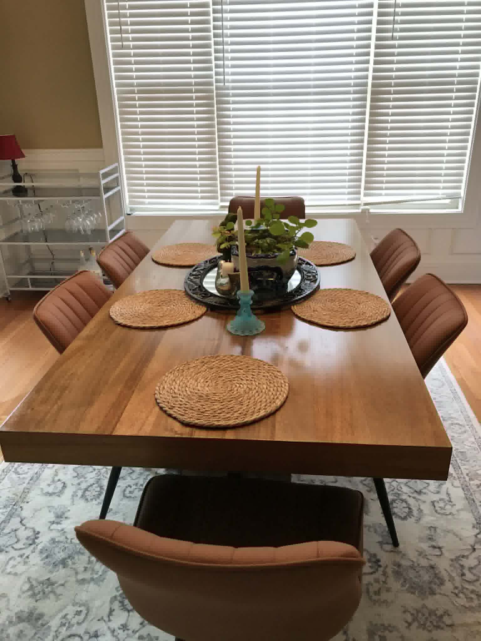 Clean dining room with wood table and leather chairs