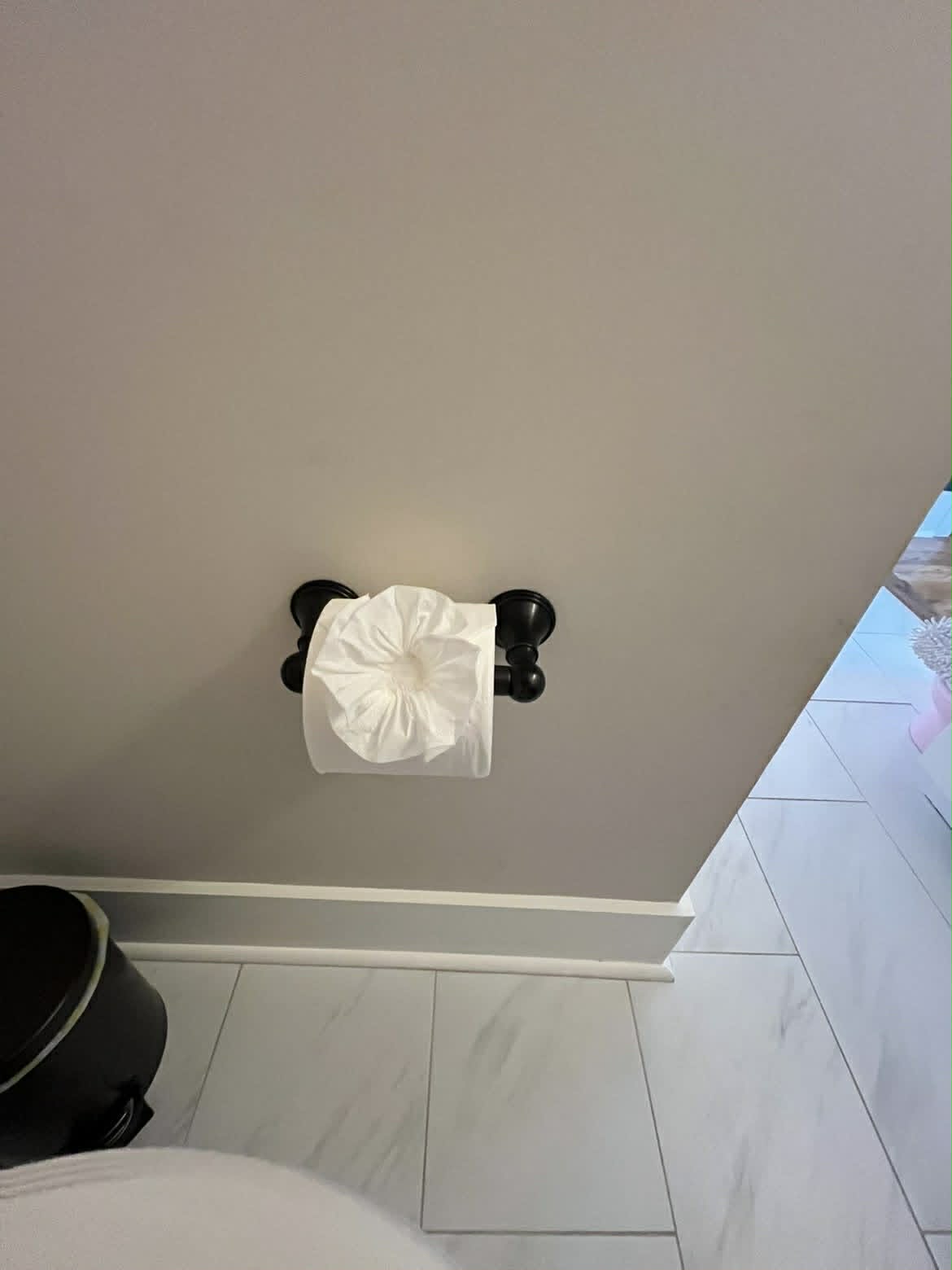 Clean bathroom with black hardware and marble tile