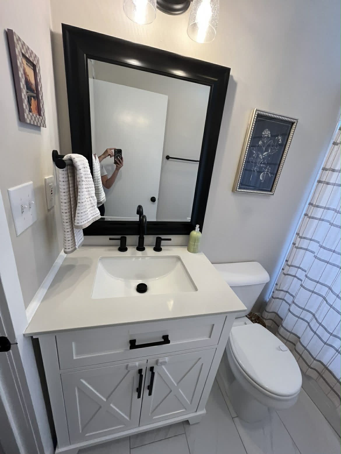 White bathroom vanity with black matte hardware